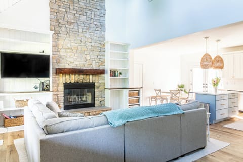 Snuggle up on the large sectional by the fireplace—perfect for those cozy nights in.