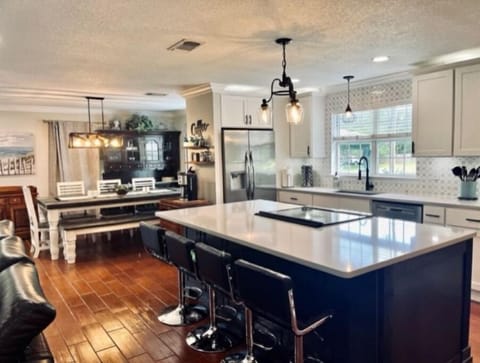 Bar stools are adjustable and comfortable. View of kitchen or turn to tv view

