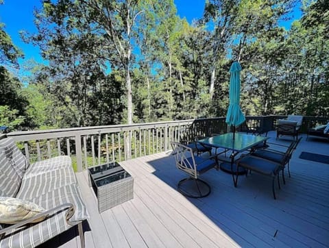 Oversized deck off of main level of the house overlooking mature trees.