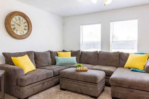 Unwind and embrace comfort in our cozy living room, bathed in natural light.