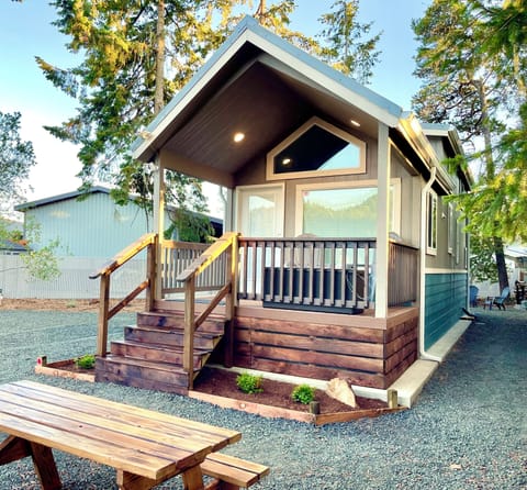 Welcome to Tiny Pines! Enjoy the spacious yard, front porch, and picnic area.