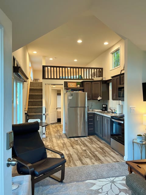 Kick back in the comfortable living room & kitchen with full-size appliances.