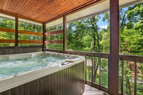 Enjoy the bubbling hot tub inside the private screened in patio.