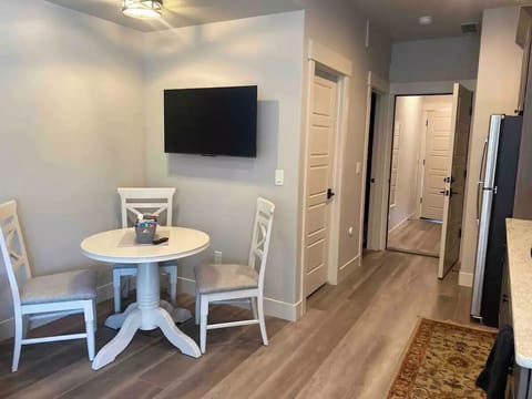 Dining table with three chairs and ROKU TV (with Netflix and Amazon Prime)
