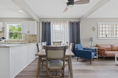 Bright open-concept space combining kitchen, dining, and living areas – perfect for gathering and entertaining.