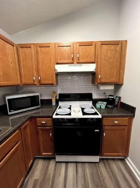 Kitchen with stove, oven, refrigerator, dishwasher, microwave and coffee machine