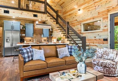 Experience the charm of our stylish open-plan living area, where classic meets contemporary in the heart of the woods.