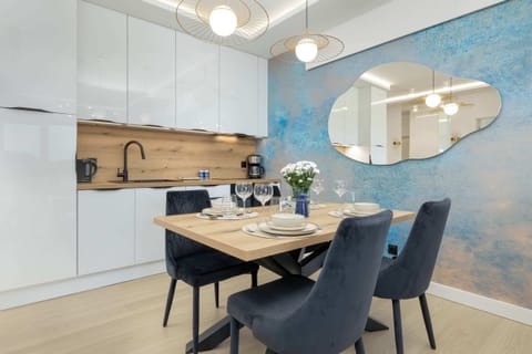 A bright and functional kitchen with white cabinets, wooden countertops, and sleek appliances, perfect for preparing meals.