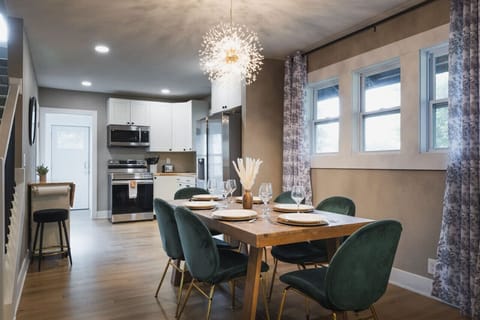 Enjoy meals in this elegant dining space, with a modern chandelier and an open-concept kitchen perfect for entertaining.