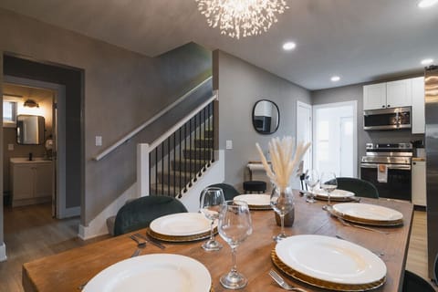 A sleek and modern kitchen flows into the dining area, with stylish details and an open feel.