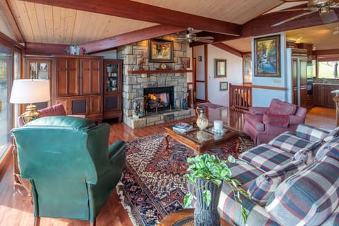 Spacious living room with stone fireplace and comfortable seating.