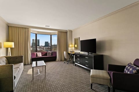 Relax by the window lounge with TV and work-ready desk.