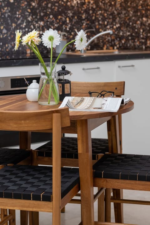 A side view of the bedroom, showcasing soft bedding, decorative pillows, and a bedside lamp for a cozy touch.

