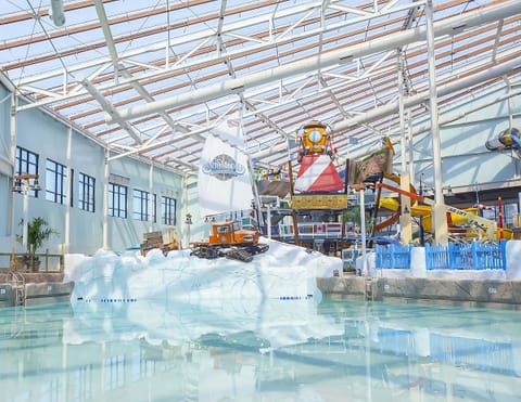 Drift through the bright indoor waterpark under sunlit beams.