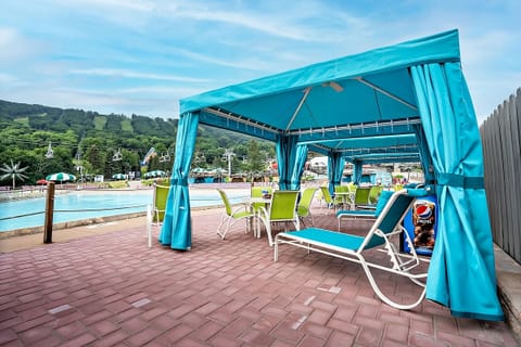 Lounge poolside in a private cabana for all-day comfort.