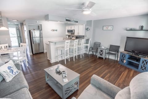 The open-concept layout connects the kitchen, dining area, and living room, creating a warm and inviting atmosphere.