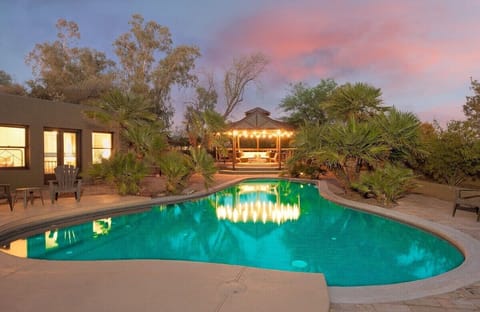 Beneath the star-studded sky, our yard transforms into an ethereal sanctuary - the pool's gentle ripples mirroring constellations while the gazebo offers a cozy retreat for nighttime reverie