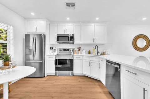 A beautifully designed spacious and modern kitchen with white shaker cabinets, marbled quartz countertops, stainless steel appliances, ice maker and fully equipped with everything you need to serve 6 - 8 guests.