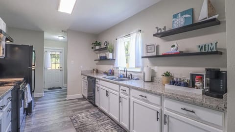 Where Culinary Wonders Unfold: A Sleek and Well-Equipped Kitchen
