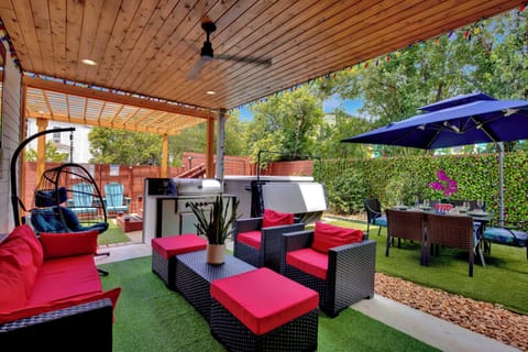 The private fenced backyard has a set of couches, a grill, swim spa&a dining set