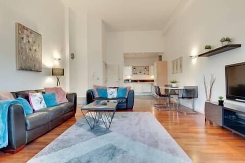Lounge area with high ceilings and an abundance of natural light