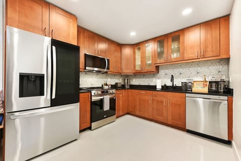 Fully equipped kitchen with stainless steel appliances and ample cabinetry