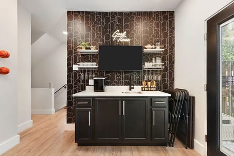 Entertainment lounge with wet bar, Smart TV, and games