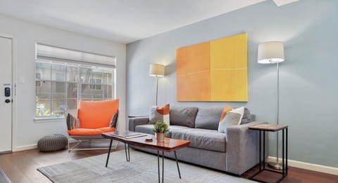 Living room with a smart tv, record player, comfortable seating, and queen sleeper