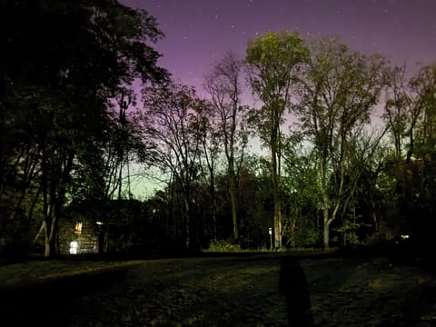 Cabin under the Northern Lights and Stars