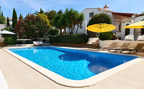 Pool with sun loungers and parasols on the terrace