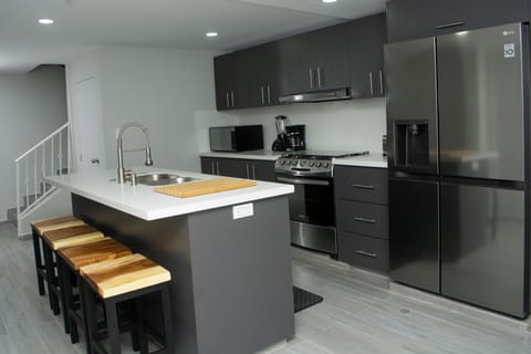 GOURTMET KITCHEN WITH NEW STAINLESS-STEEL APPLIANCES.