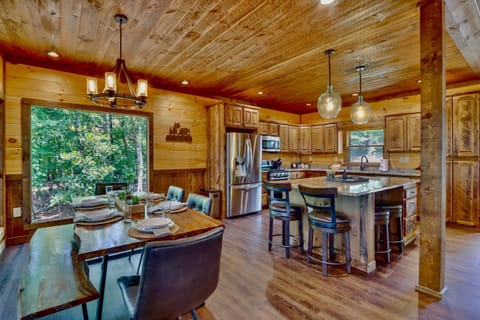 Rustic kitchen and dining room with forest views and handcrafted wood details
