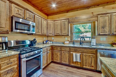Fully equipped rustic kitchen with stainless appliances and wood cabinetry in North Georgia cabin