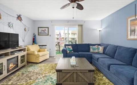 Living room w. pullout couch that overlooks the water and walks out to balcony.