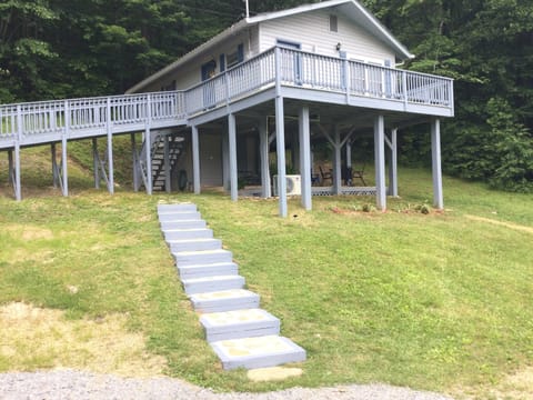 Outside view with rock steps from parking area leading to steps for front door