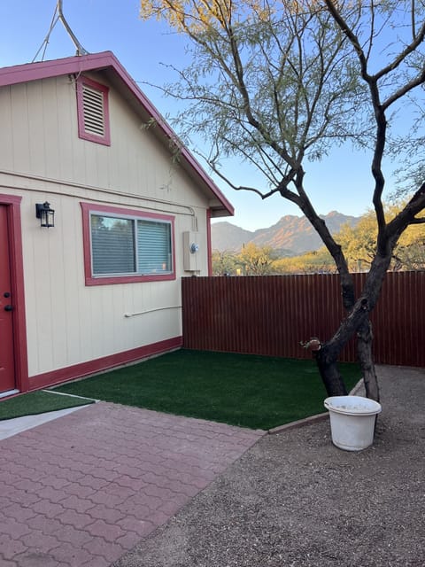 Private outdoor fenced yard. Evergreen turf and brick patio. Outdoor seating.