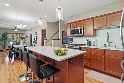Fully stocked kitchen with island and barstool seating.