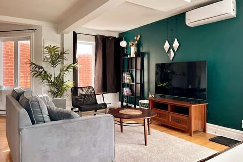 Elegant living area with a striking teal green wall—adding a touch of sophistication and charm.