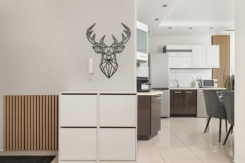 A stylish hallway with modern décor and a unique wall-mounted deer head decoration.