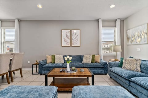 Our living room is equipped with a TV and ample plush seating, perfect for relaxation and entertainment.