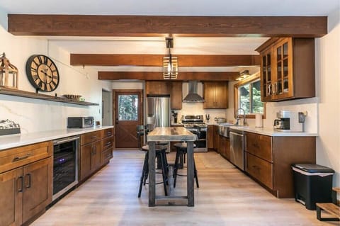 The kitchen has ample counter space as well as a kitchen island with two bar stools providing a great spot to grab a snack or keep the chef company.