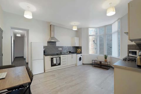 Kitchen equipped with all essentials, including a washer & dryer, oven, fridge and full cookware set.