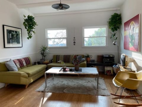 vintage furniture, original art and plant filled