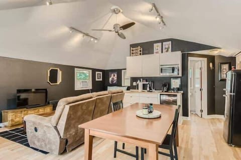 Bright and airy dining area with large windows and cozy seating for memorable meals.