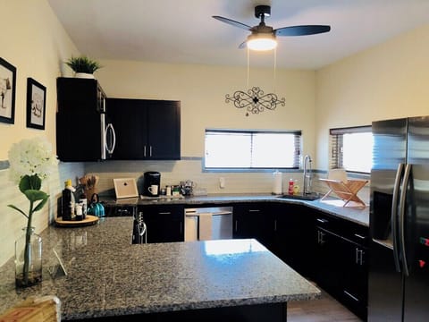 Neat kitchen with kettle, microwave, dishwasher, and more for easy cooking.