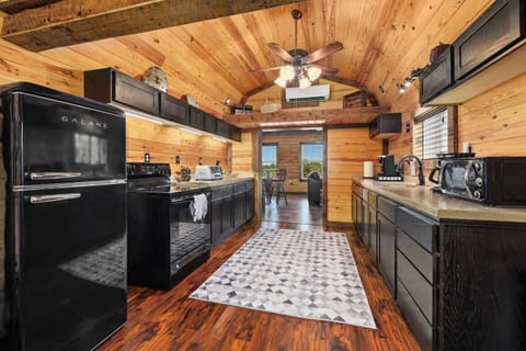 Opposite view of spacious, well-stocked kitchen