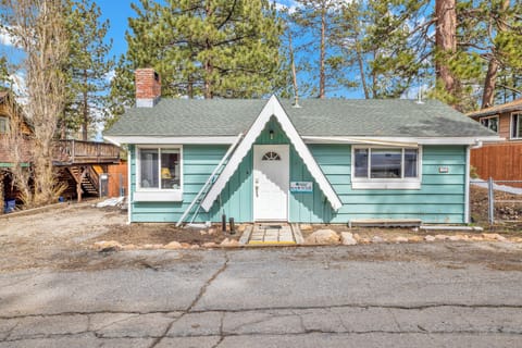 Welcoming cabin entry surrounded by towering pine trees, offering fresh mountain air and a peaceful forest setting—the perfect first impression for your Big Bear Lake getaway.
