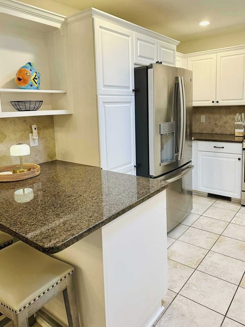 The refrigerator has an ice and water dispenser in the door, and there's a small bar for kids (or adults) to enjoy breakfast or a quick snack.