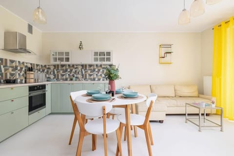 A dining area with a wooden table and chairs, complemented by a bright and airy atmosphere.