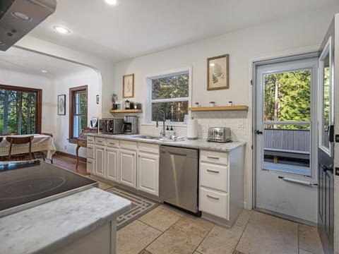 A spacious, full- kitchen with access to the outside deck and bbq.